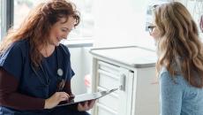 Doctor with tablet talking to patient