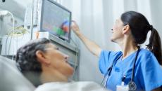 Healthcare worker checking patient's vitals