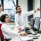 Healthcare workers looking at a medical image on a monitor