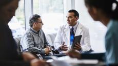 Doctor showing tablet to patient