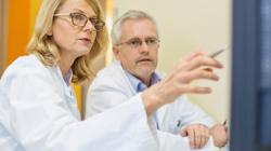 Female doctor pointing at screen.