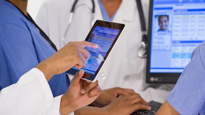 doctor looking on tablet at personal health records