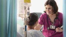 Healthcare worker talking to patient in hospital