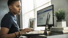 Person using a laptop with an external monitor