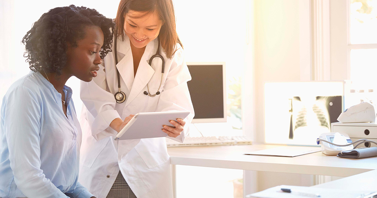 Medical worker showing patient tablet