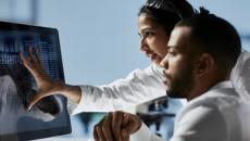 Healthcare workers looking at display screen