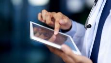 A doctor holding a tablet.