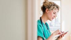 A nurse viewing their schedule on a digital tablet 