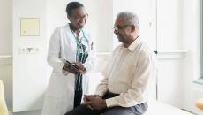 Doctor showing tablet to patient