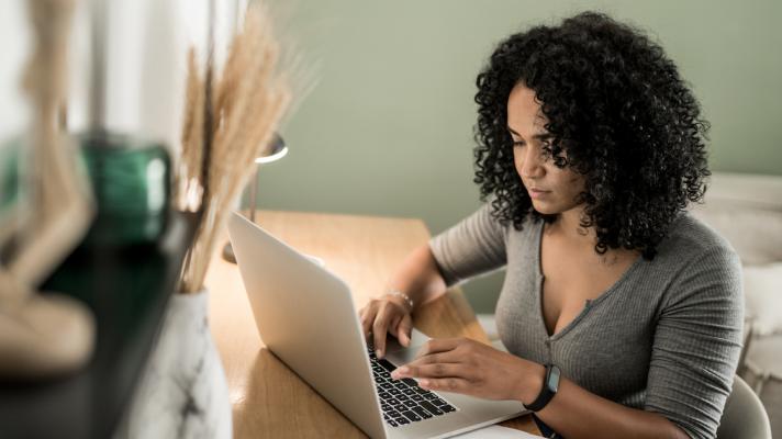 Healthcare patient at home desk with laptop