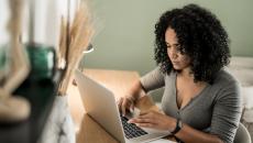 Healthcare patient at home desk with laptop